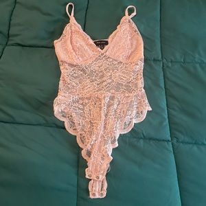 Cute light pink bodysuit, size 4 but fits like a 0 or 2. Brand New Look.